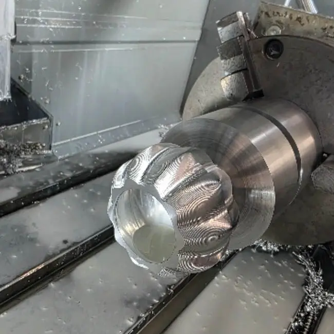 Close-up of a 4th-axis cnc milling machine working 6082 T6 aluminium into a pumpkin shape