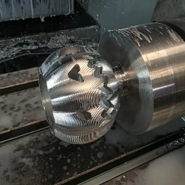 Close-up of a 4th-axis cnc milling machine showing precision